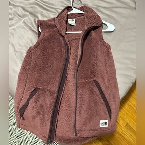 Maroon colored North face fur vest